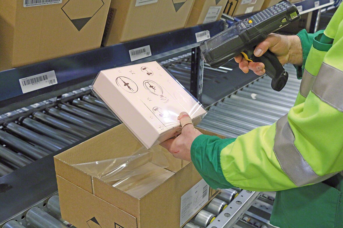 Kommissionierer, der einen Artikel mithilfe eines Handscanners entnimmt, der mit der Kommissioniersoftware verbunden ist. Kommissionierer, der einen Artikel mithilfe eines Handscanners entnimmt, der mit der Kommissioniersoftware verbunden ist.