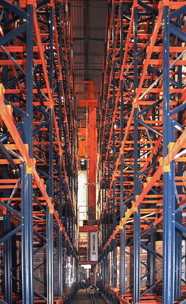 The 15 m tall stacker cranes are automatically summoned to gather any pallets diverted to their lane for put away